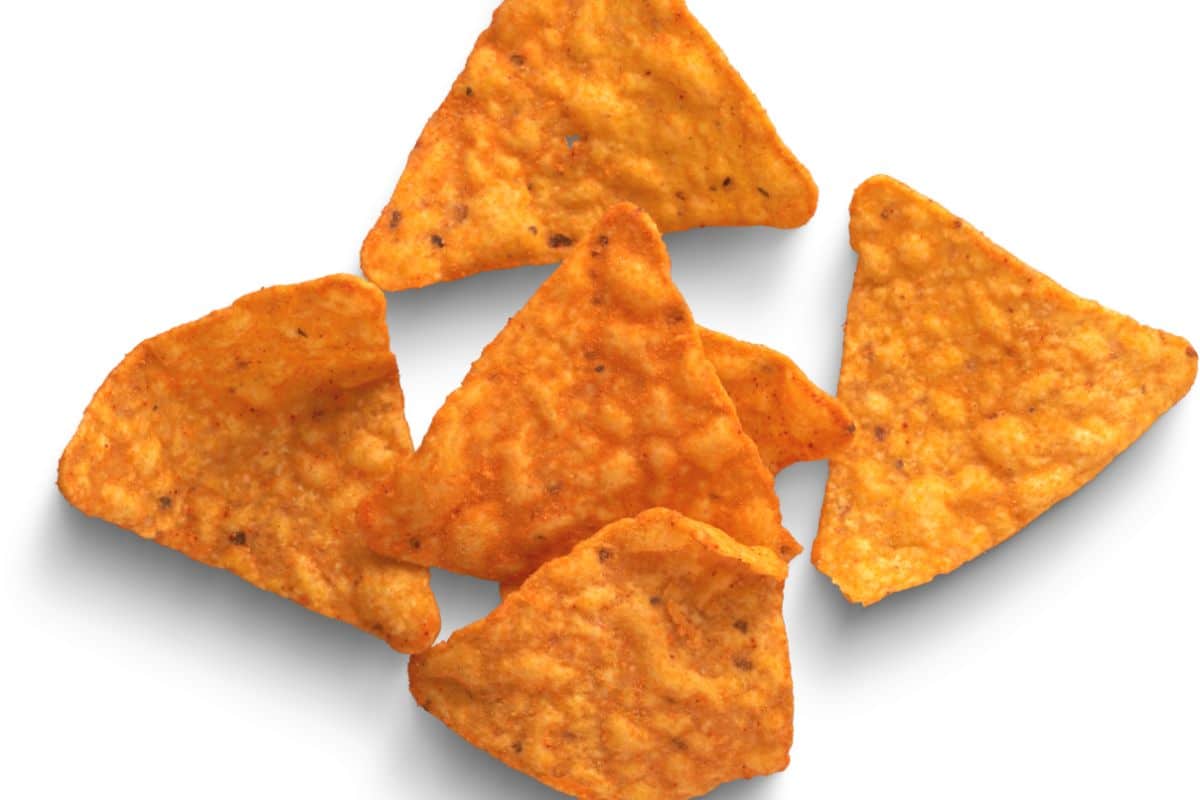 some doritos chips on a white plate.