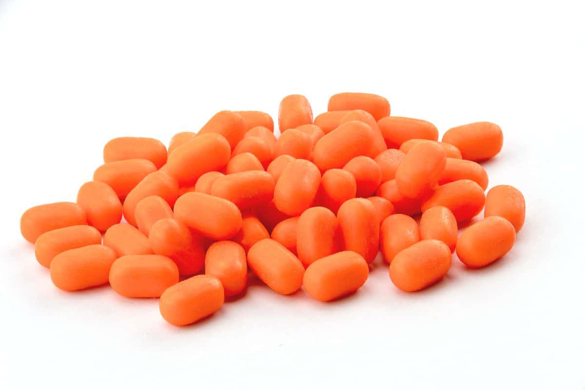 a pile of orange tic tacs.