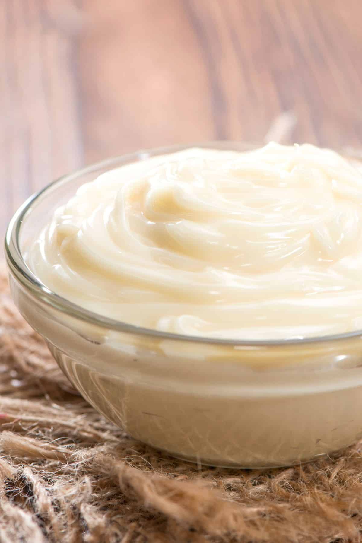 A small glass bowl filled with homemade mayo.