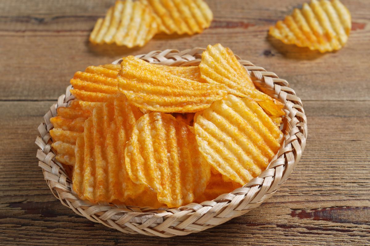 A basket of flavored ruffles potato chips.